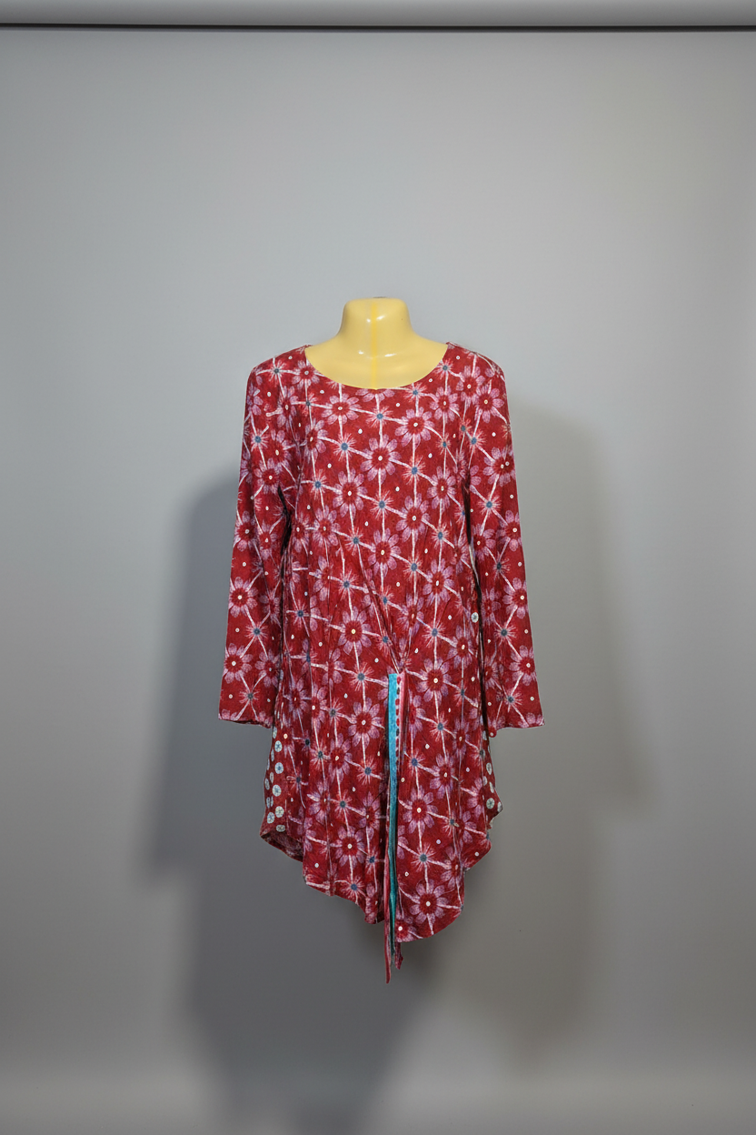 A red and white patterned long-sleeve tunic top displayed on a yellow mannequin torso against a plain gray background.