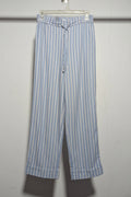 Blue and white striped pants hanging on a rack against a white wall.