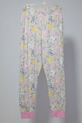 Floral-patterned pants hanging on a rack with other clothing items.