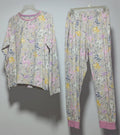 Floral pajama set hanging on a rack against a white wall.