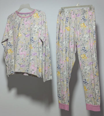 Floral pajama set hanging on a rack against a white wall.