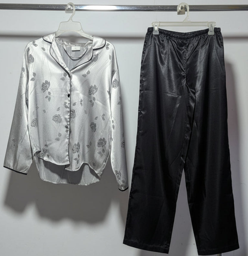 Clothing items hanging on a rack against a white wall.
