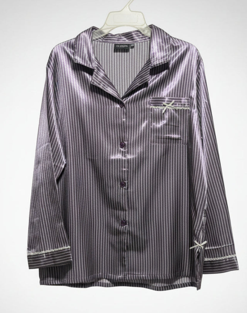 Striped shirt with a logo on a hanger against a plain background