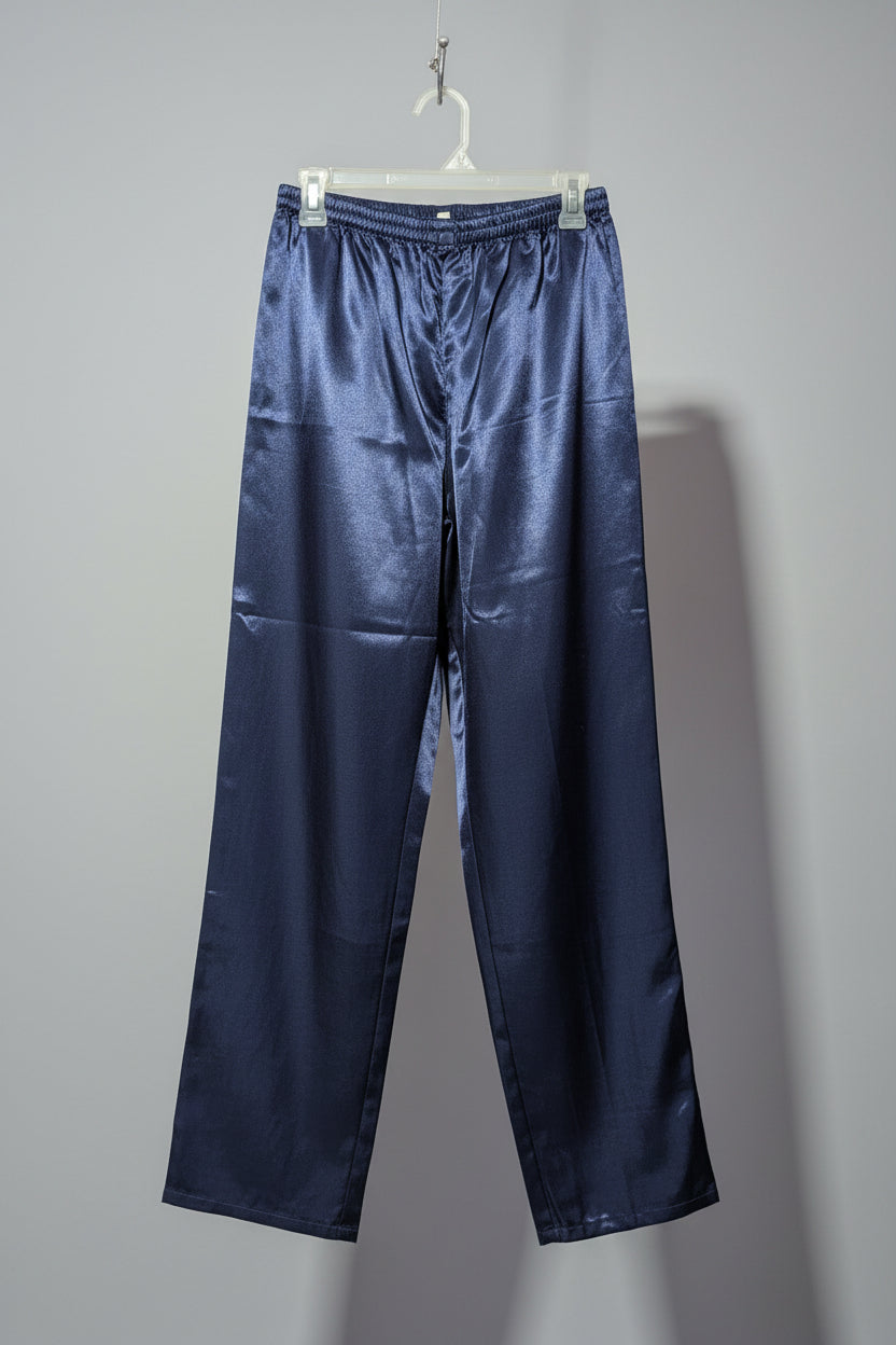 Navy satin pants hanging on a white hanger against a gray background