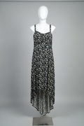 Floral dress on a mannequin against a white wall with a patterned floor.