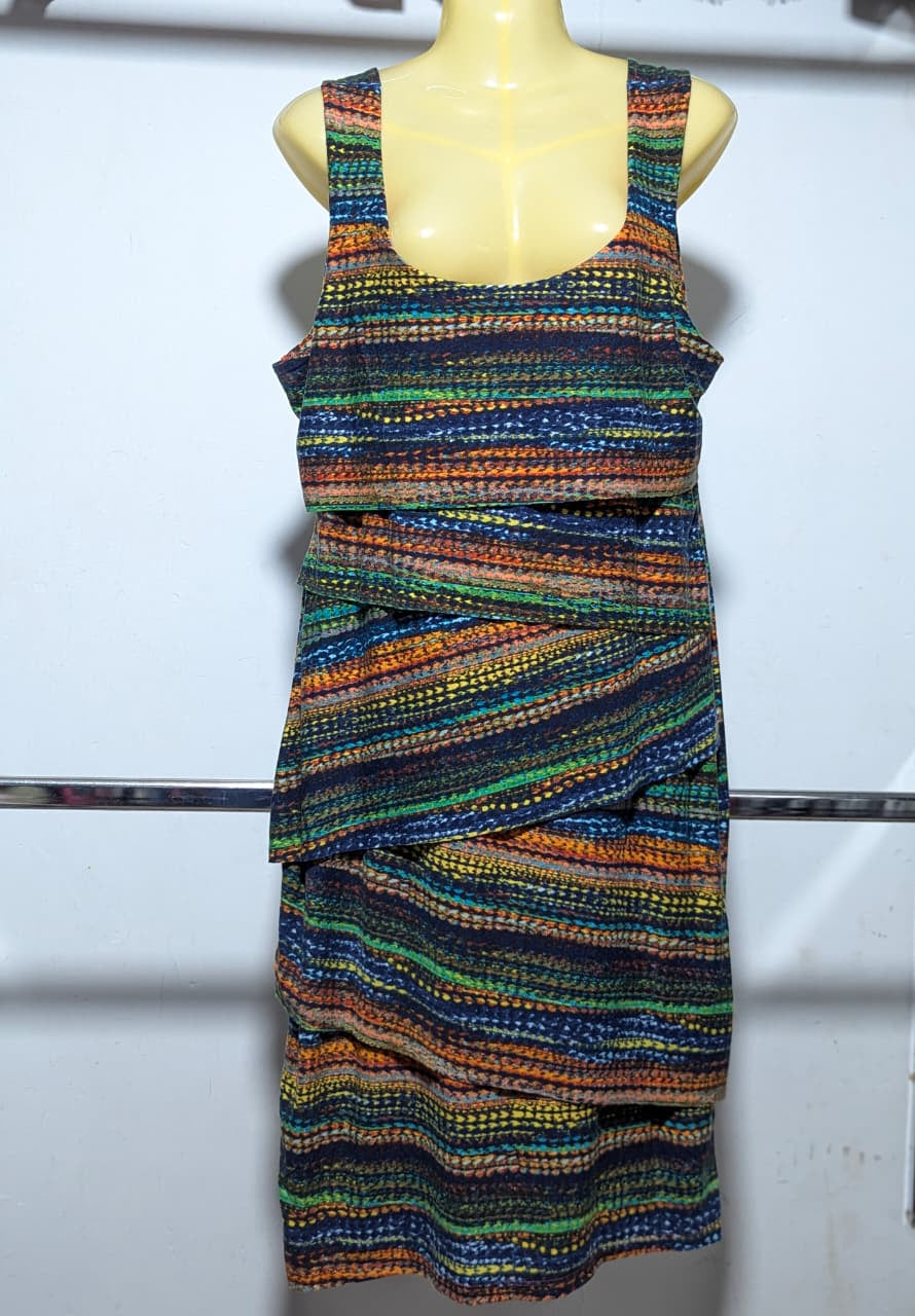 Multicolored patterned dress on a mannequin against a white background