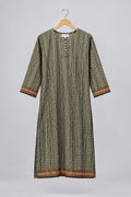A three-quarter sleeve tunic dress with a vertical geometric pattern in olive green, black, and white, featuring brown and gold patterned borders on the cuffs and hem, hanging on a hanger against a white wardrobe door.