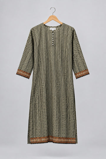 A three-quarter sleeve tunic dress with a vertical geometric pattern in olive green, black, and white, featuring brown and gold patterned borders on the cuffs and hem, hanging on a hanger against a white wardrobe door.