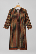 A long-sleeve tunic dress with a vertical striped pattern in brown, black, orange, and cream, hanging on a wooden hanger against a light gray background.