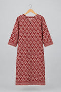 A red and white patterned cotton tunic dress with three-quarter sleeves hanging on a metal hanger against a white wardrobe door.
