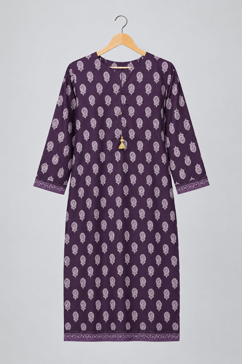 A purple long kurta with a white block print pattern, hanging on a metal hanger against a white wardrobe door.