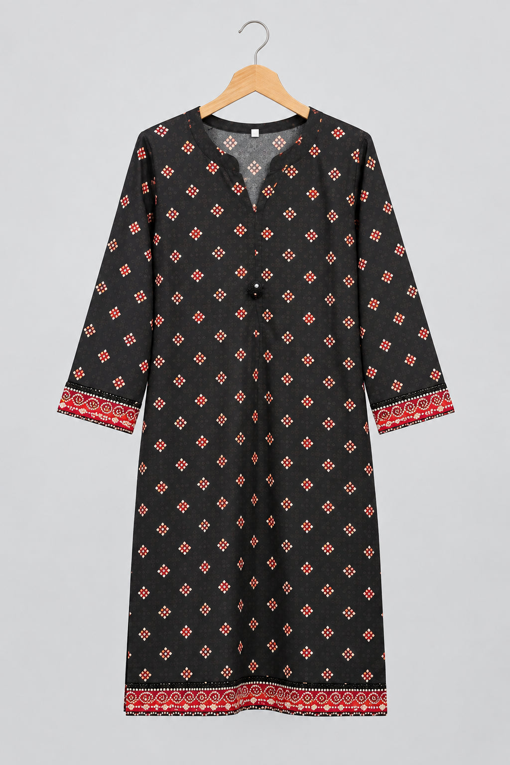 A black three-quarter sleeve tunic or kurta with a red and orange geometric pattern and red patterned cuffs, hanging on a metal hanger against a white wardrobe door.